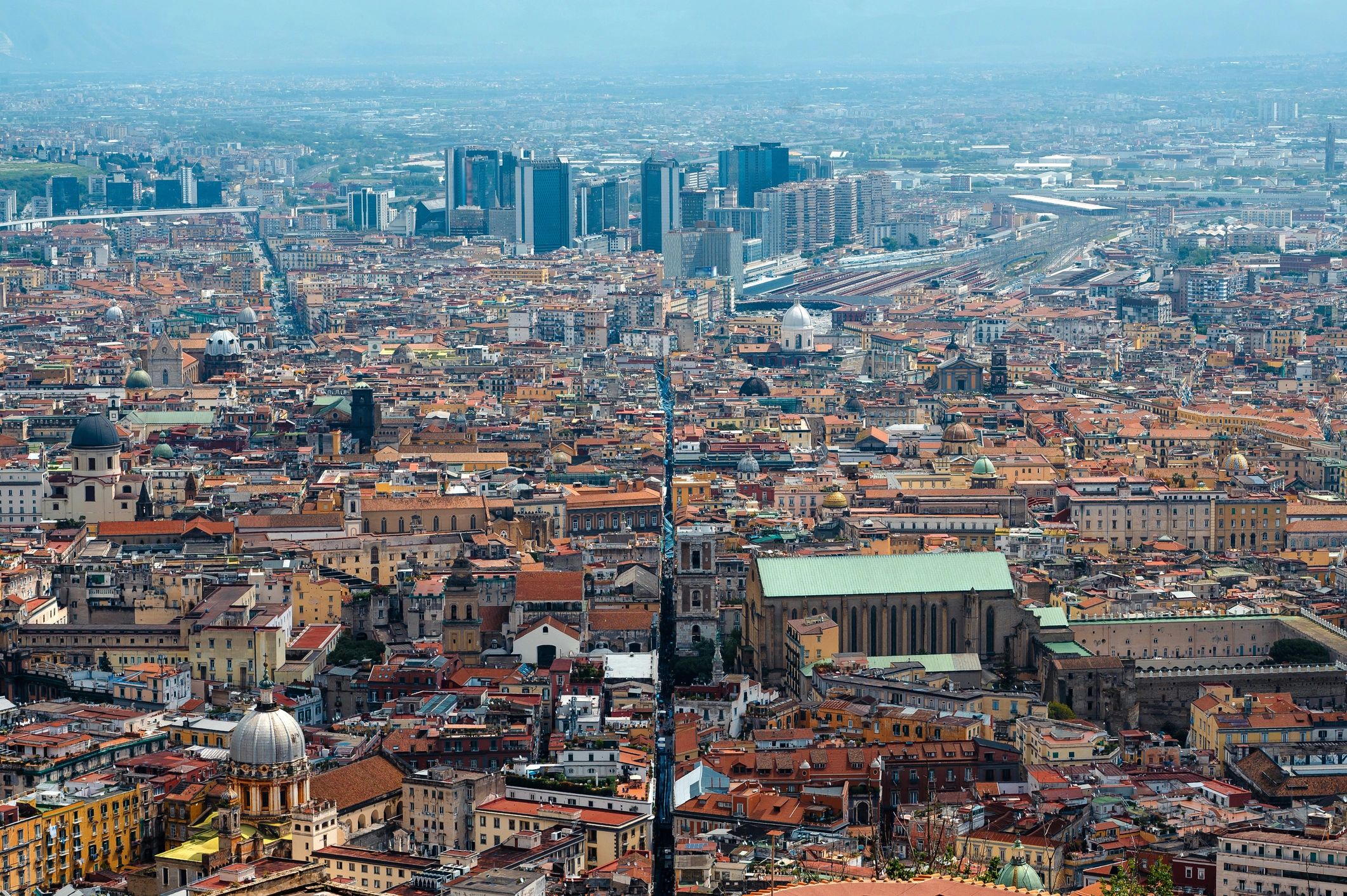 Wide cityscape of Naples with layered historic buildings