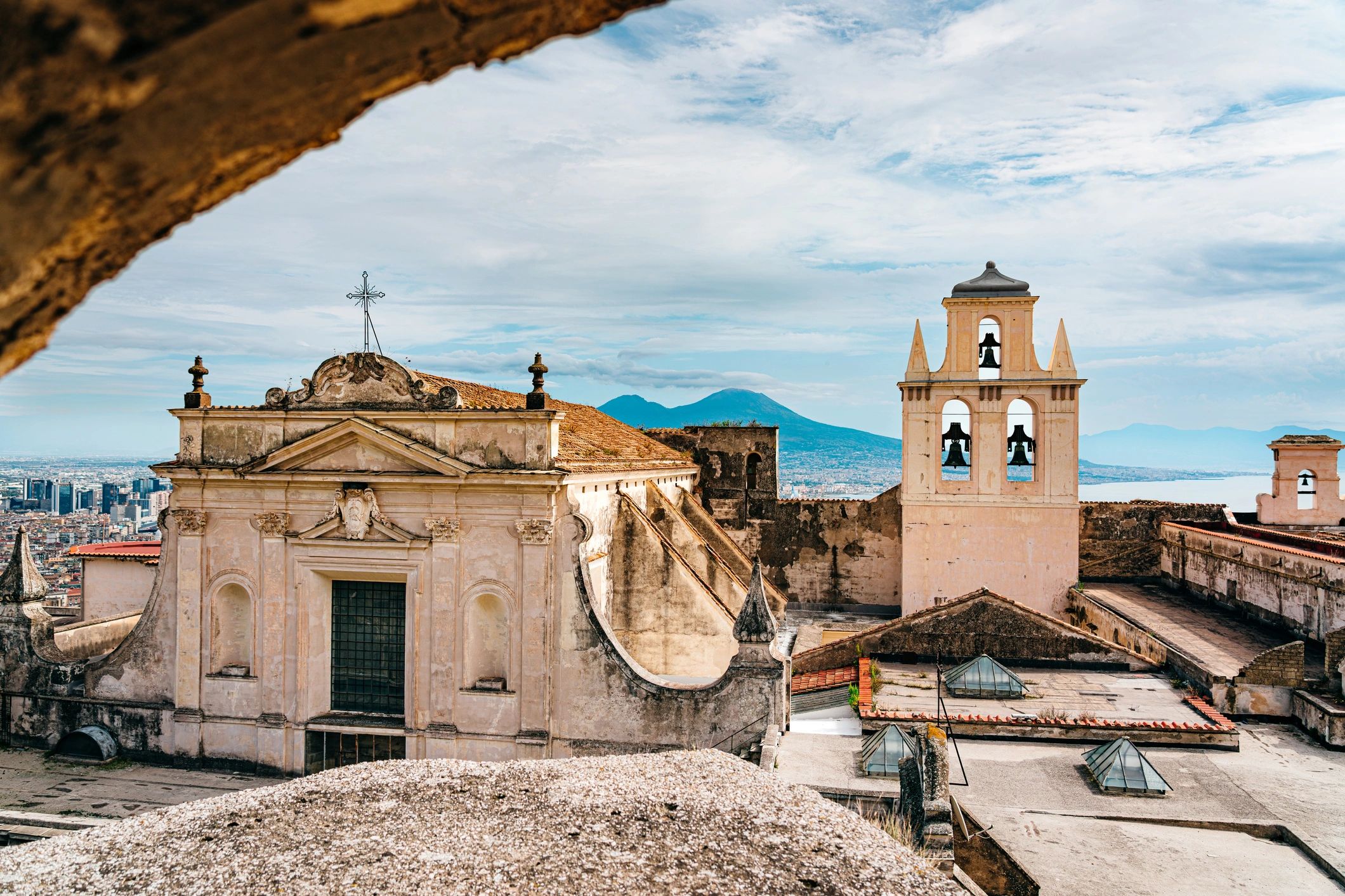 Church rooftops and bell tower above Naples